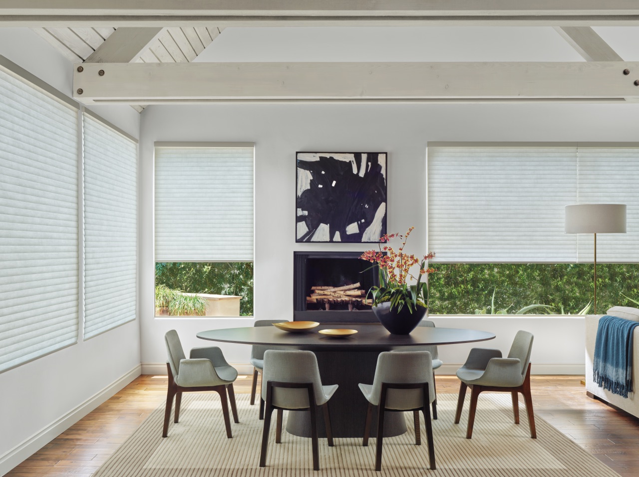 Sonnette® Cellular Roller Shades in a bright dining room with white cellular fabric and softly filtered daylight