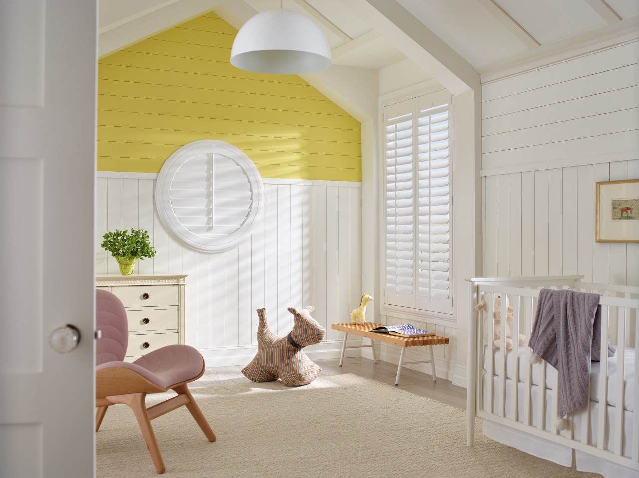 Heritance® Hardwood Shutters in a bright nursery with custom white hardwood panels and warm daylight