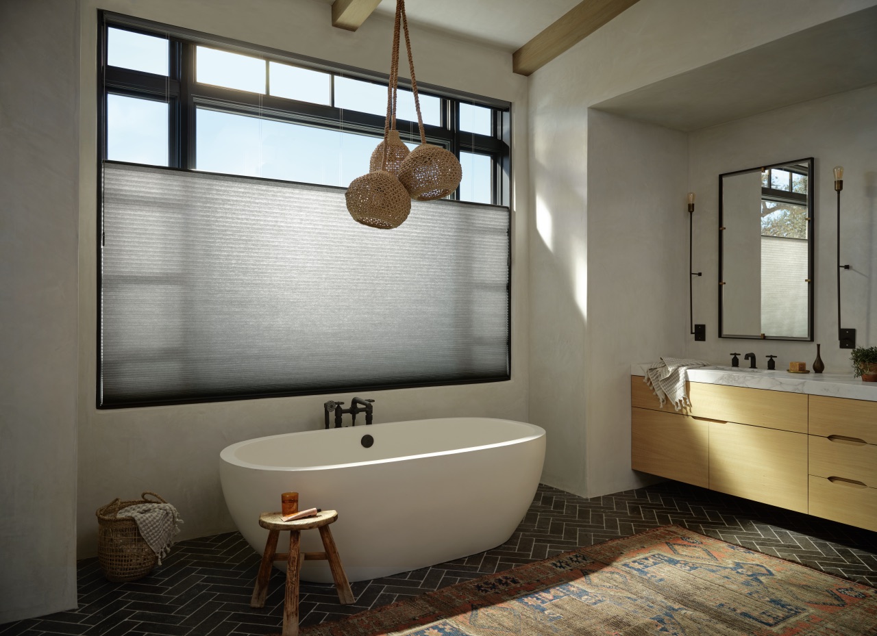 Duette® Honeycomb Shades in a softly lit bathroom with dark cellular fabric and filtered daylight
