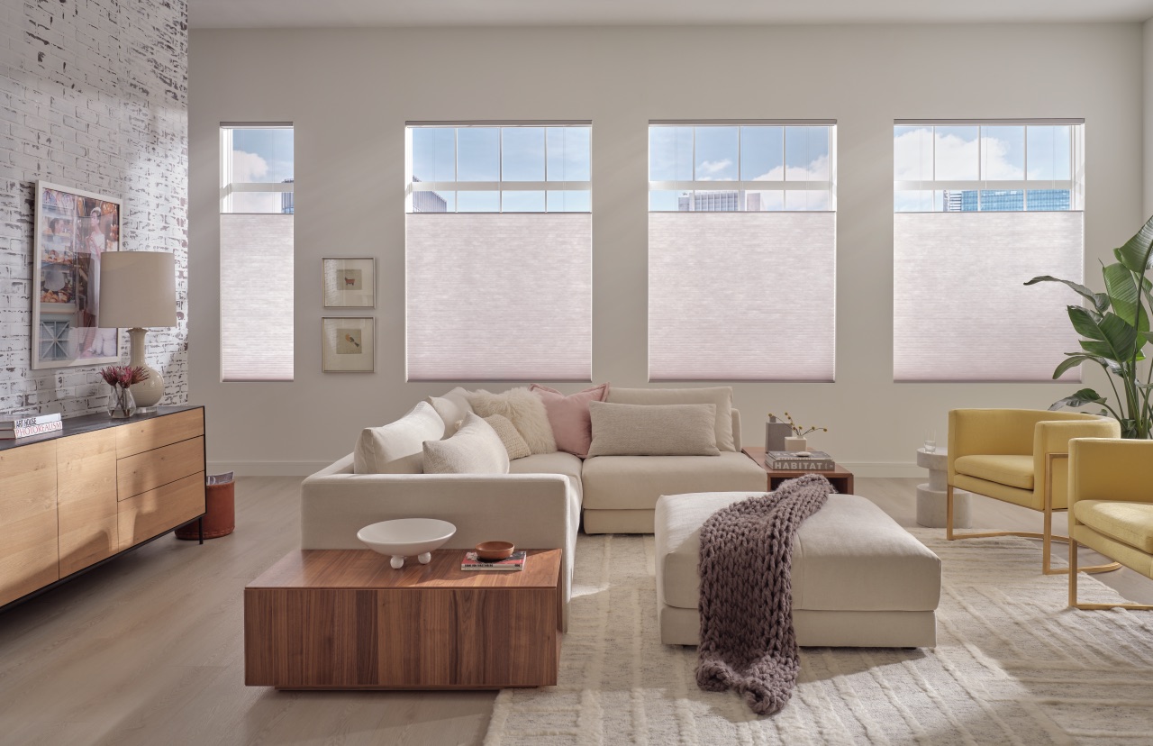 Applause® Honeycomb Shades across a bright living room with softly filtered daylight and four large windows
